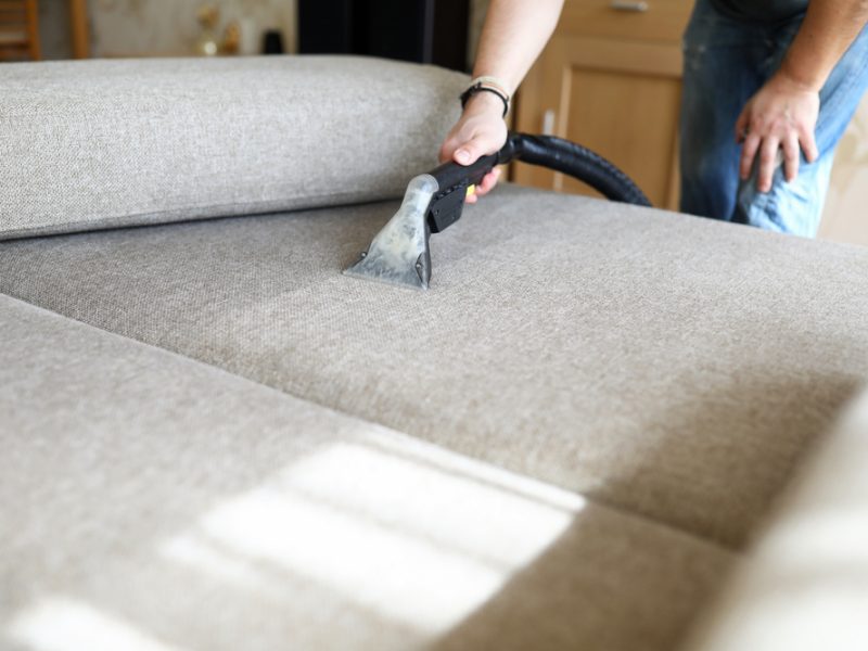 Interior cleaning staff cleaning dirty couch